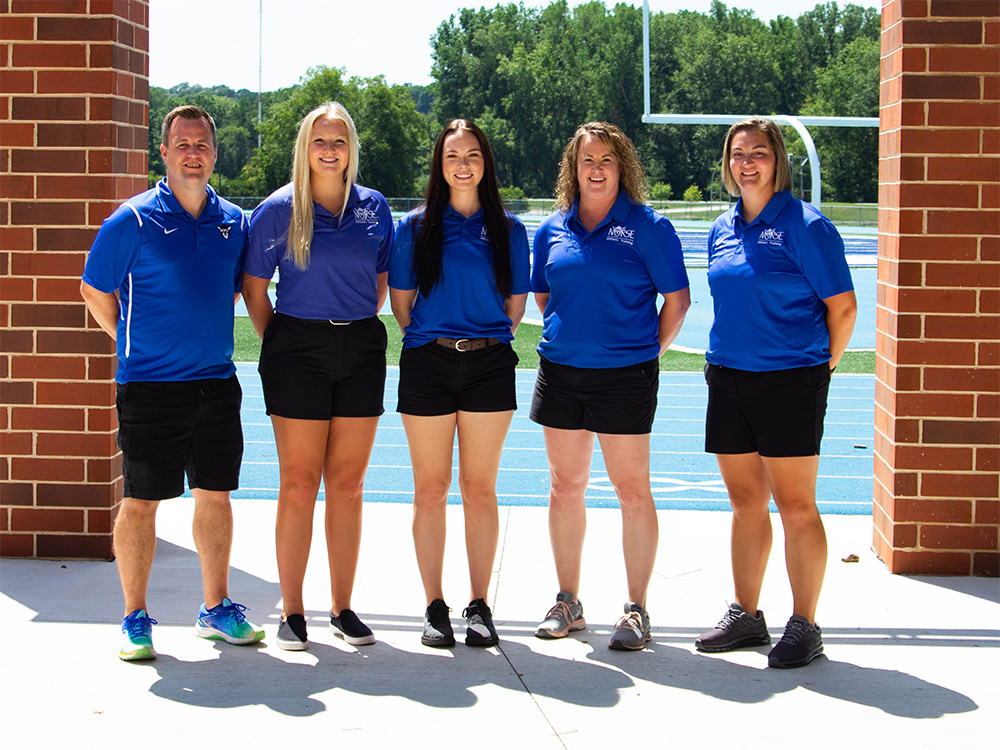 Luther College athletic trainers stand outdoors for a group picture.